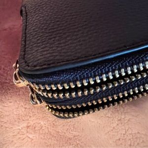 Coach wristlet with gold hardware. 8” wide 4 1/2” high with leather Coach tag